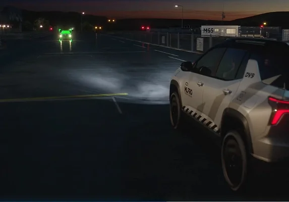 2027 Chevrolet Bolt driving at night with IntelliBeam automatic high beams illuminating the road ahead