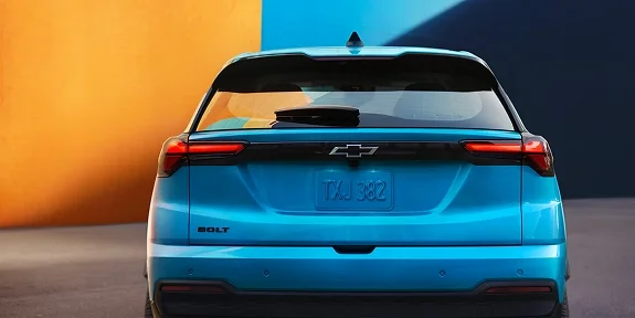 Rear view of the 2027 Chevrolet Bolt in blue showing the full-width LED tail light bar