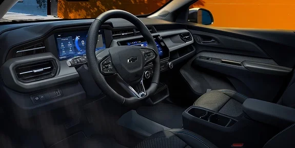 2027 Chevrolet Bolt interior viewed from the passenger side showing the dashboard, steering wheel, and center console