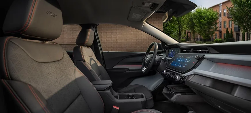 2027 Chevrolet Bolt RS interior showing black Evotex seats with red stitching and the touchscreen display